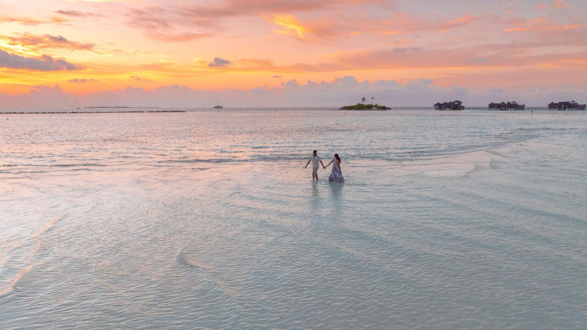 couple holding hands on a secluded island