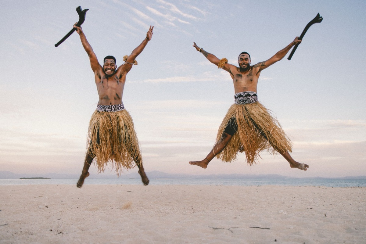 Fijian traditional dance performers in colorful costumes