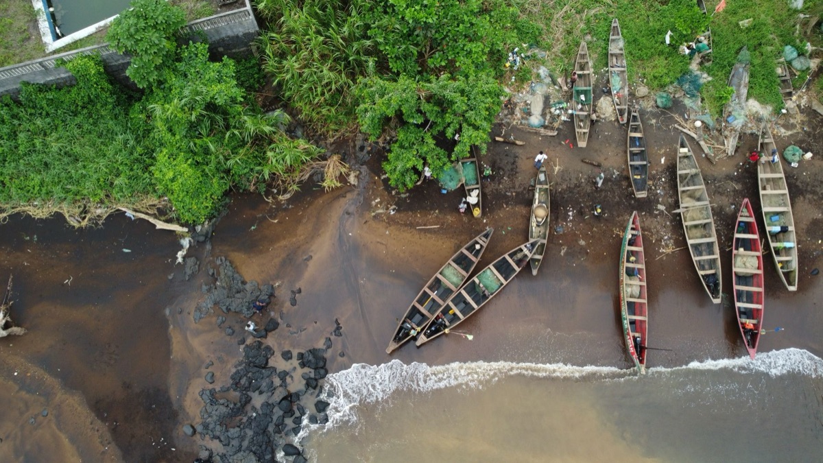 fiji village with traditional canoe